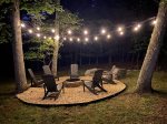 Outdoor fire pit with Adirondack seating for 6 and lighting for evening enjoyment